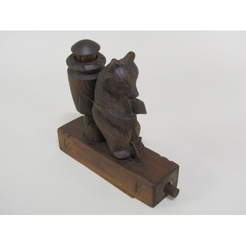 48 - An early 20c Black Forest carved wood bear novelty in the form of a grape picker with a China man in... 