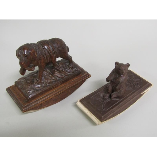 49 - Two carved wood Black Forest desk blotters, one mounted with a seated bear, the other with a Saint B... 