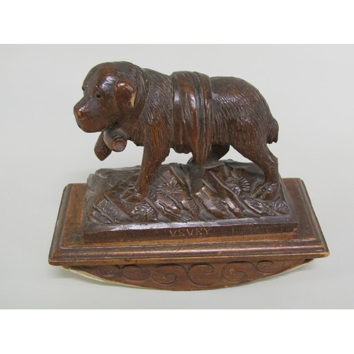 49 - Two carved wood Black Forest desk blotters, one mounted with a seated bear, the other with a Saint B... 