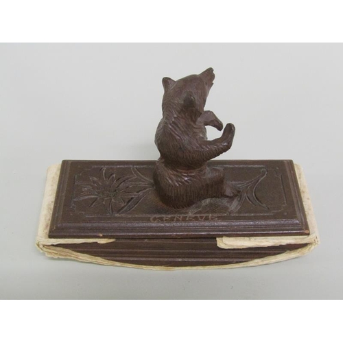 49 - Two carved wood Black Forest desk blotters, one mounted with a seated bear, the other with a Saint B... 