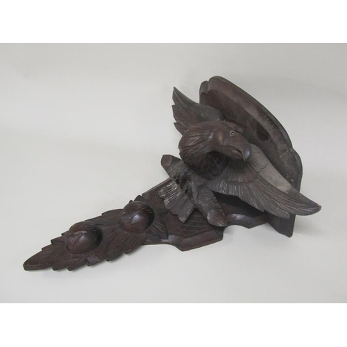 57 - A pair of late 19c/early 20c carved wood eagle wall brackets, 49cm h.  The brackets 32cm w.