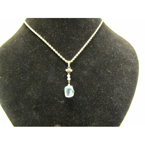 133 - A gold pendant set with square Aquamarine suspended by seed pearls and diamonds on a 9ct chain, 3.7g... 