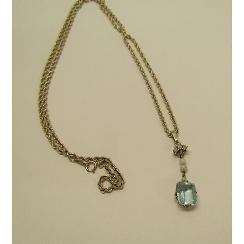 133 - A gold pendant set with square Aquamarine suspended by seed pearls and diamonds on a 9ct chain, 3.7g... 