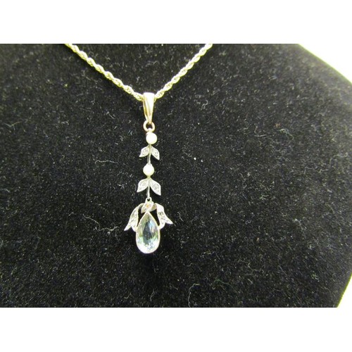 134 - A Edwardian 9ct gold drop aquamarine pendant set with suspended cut white garnet stones and seed pea... 