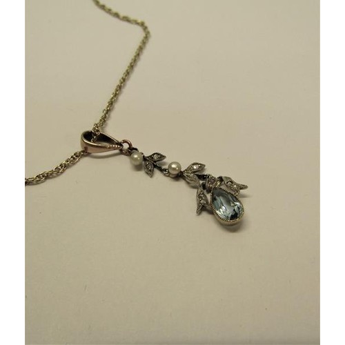 134 - A Edwardian 9ct gold drop aquamarine pendant set with suspended cut white garnet stones and seed pea... 