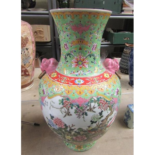 265 - A Chinese Republican period baluster vase of green floral pattern ground, having two pink glazed lio... 