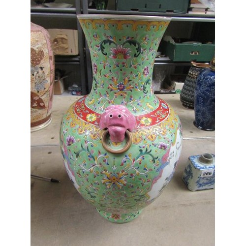 265 - A Chinese Republican period baluster vase of green floral pattern ground, having two pink glazed lio... 