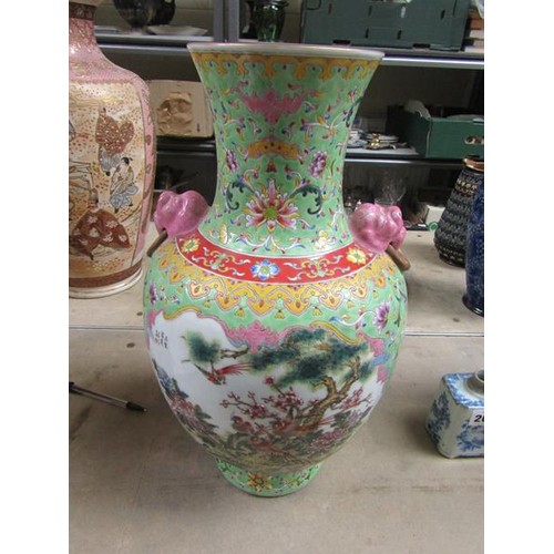 265 - A Chinese Republican period baluster vase of green floral pattern ground, having two pink glazed lio... 