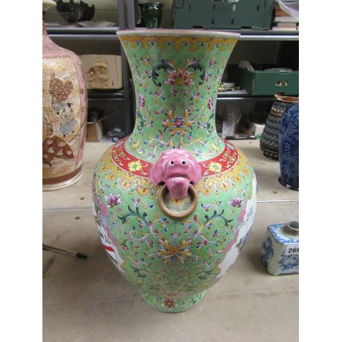 265 - A Chinese Republican period baluster vase of green floral pattern ground, having two pink glazed lio... 