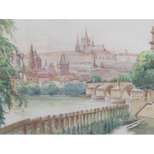 1156 - JOSIE MAC - RIVERSCAPE WITH DISTANT TOWN AND CHURCHES, WATERCOLOUR.  F/G 24 x 27cms