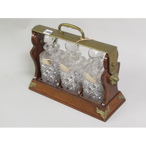 1338 - THREE BOTTLE TANTALUS WITH SILVER LABELS, 37CM W, 15cm deep, 31cm h