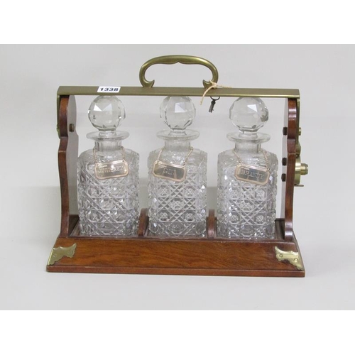 1338 - THREE BOTTLE TANTALUS WITH SILVER LABELS, 37CM W, 15cm deep, 31cm h