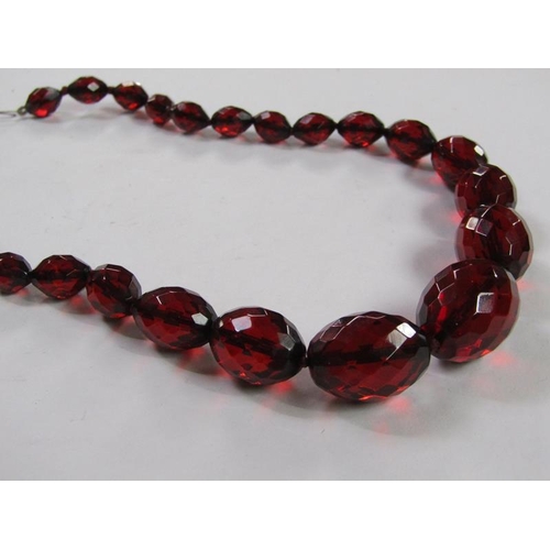 1413 - CUT RED AMBER TYPE BEAD NECKLACE TOGETHER WITH BLUE STONE SET SILVER MOUNTED PENDANT AND CHAIN