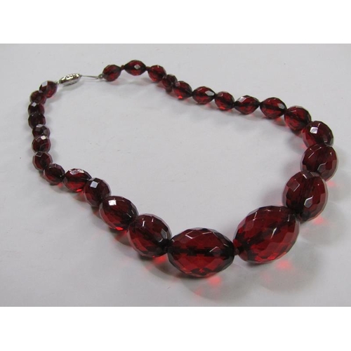 1413 - CUT RED AMBER TYPE BEAD NECKLACE TOGETHER WITH BLUE STONE SET SILVER MOUNTED PENDANT AND CHAIN