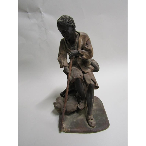 1619 - POTTERY FIGURE - AFRICAN BOY SEATED, A/F, 19CM H