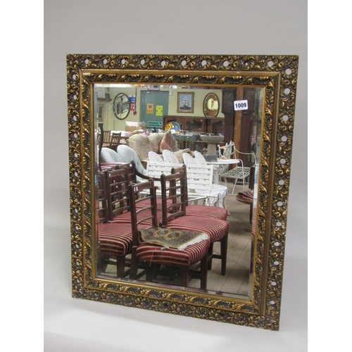 1009 - MOULDED GILT FRAMED WALL MIRROR, 70 x 59 cms