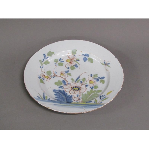 226 - An 18c Delft polychrome dish of circular form, decorated with flowers and foliage, 33cm diam.