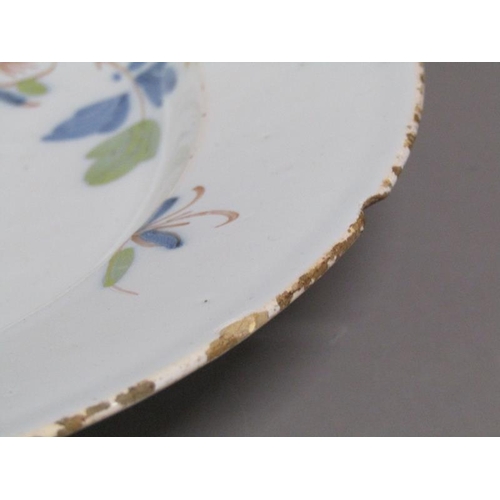 226 - An 18c Delft polychrome dish of circular form, decorated with flowers and foliage, 33cm diam.