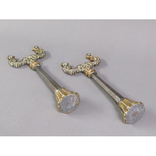 26 - A pair of 19c brass and steel andirons, the scrolling brass rests supported on facet tapering steel ... 