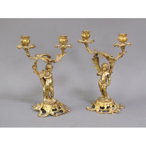 28 - A pair of late 19c rococo ormolu figurative two branch candelabra with cherub columns, 28cm h.