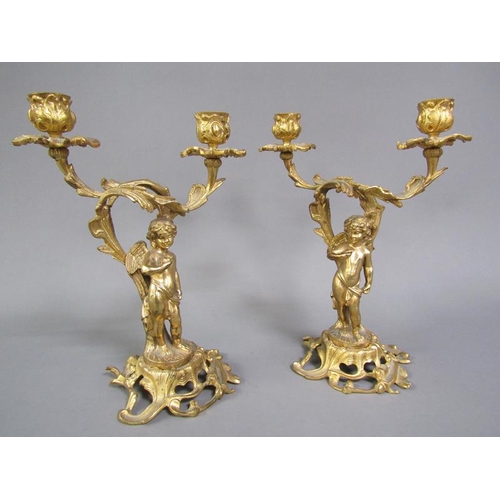 28 - A pair of late 19c rococo ormolu figurative two branch candelabra with cherub columns, 28cm h.