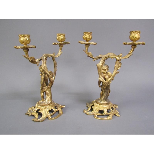 28 - A pair of late 19c rococo ormolu figurative two branch candelabra with cherub columns, 28cm h.