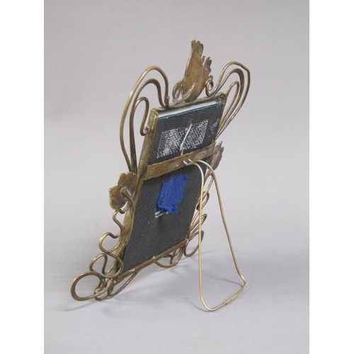 29 - An Art Nouveau brass easel photograph frame with an open scrolling floral mount, 25cm h, 20cm w over... 