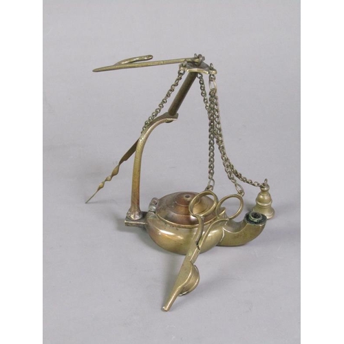 31 - A Continental brass hanging floating wick lamp with three suspended chained tools, 17cm h.