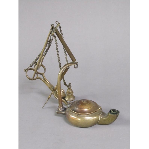 31 - A Continental brass hanging floating wick lamp with three suspended chained tools, 17cm h.