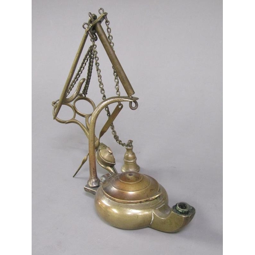 31 - A Continental brass hanging floating wick lamp with three suspended chained tools, 17cm h.