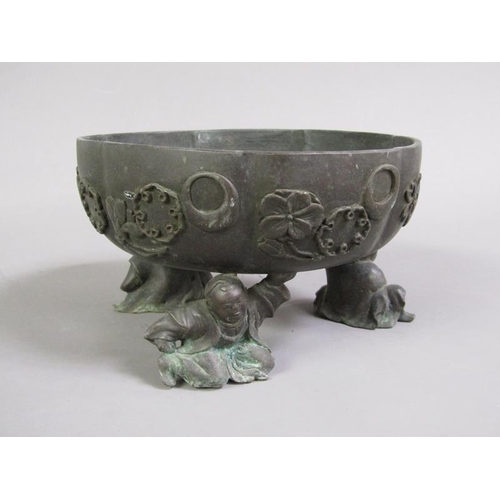 33 - A 19c Oriental patinated bronze censer in the form of a bowl, cast with flowers and crescents, suppo... 