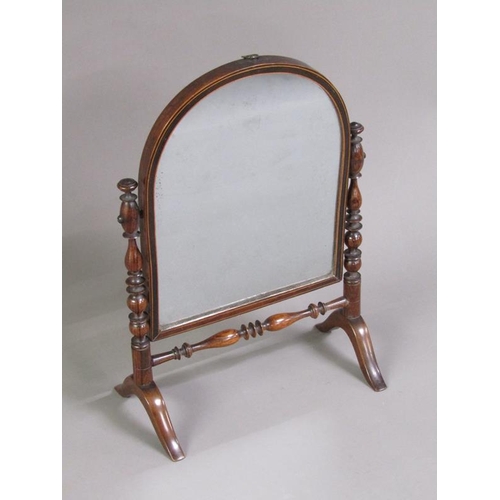 47 - A Regency period rosewood toilet glass, the arched mirror with a line inlaid border, supported on ri... 