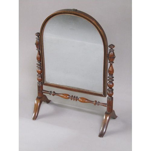 47 - A Regency period rosewood toilet glass, the arched mirror with a line inlaid border, supported on ri... 