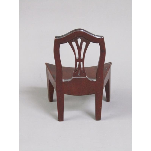 51 - A late Georgian mahogany miniature single chair with a concave solid seat, pierced vase splat, shape... 