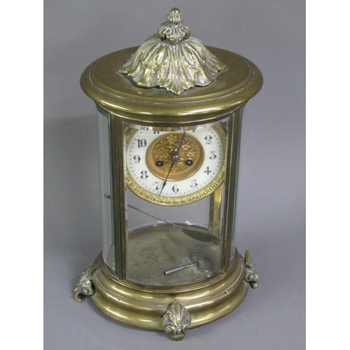 14 - A late 19c French four glass clock in oval brass case with bevelled oval glass side panels and doors... 