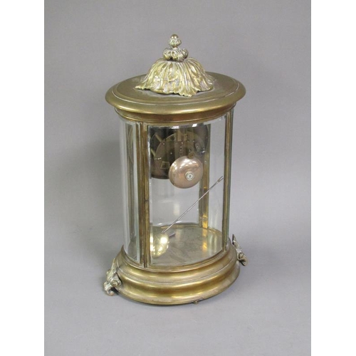 14 - A late 19c French four glass clock in oval brass case with bevelled oval glass side panels and doors... 