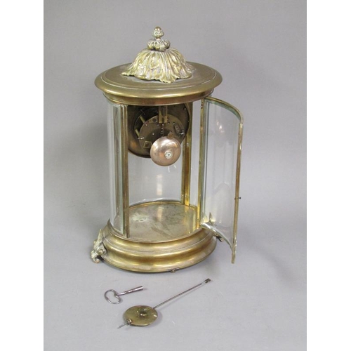 14 - A late 19c French four glass clock in oval brass case with bevelled oval glass side panels and doors... 