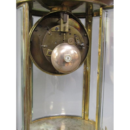 14 - A late 19c French four glass clock in oval brass case with bevelled oval glass side panels and doors... 