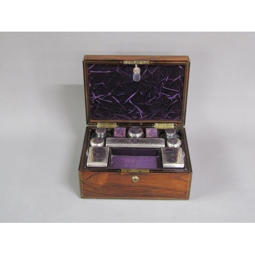 41 - A George IV figured walnut travelling box with brass rail inlay and edging, the box with original ve... 