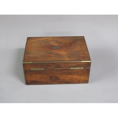 41 - A George IV figured walnut travelling box with brass rail inlay and edging, the box with original ve... 