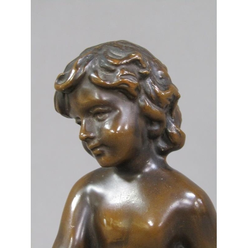 71 - A late 19c/early 20c patinated bronze figure of a young child seated upon a tree stump with a basket... 