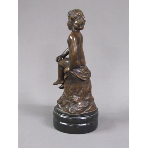 71 - A late 19c/early 20c patinated bronze figure of a young child seated upon a tree stump with a basket... 