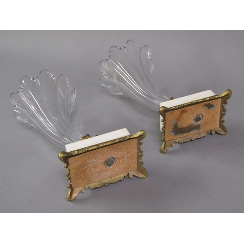 77 - A pair of early 19c rams head cornucopia, the cut clear glass vases supported by gilt metal rams hea... 