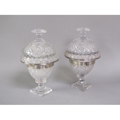 80 - A pair of early 19c cut glass bonbonnieres with lift off covers, having cut finials, the bowls with ... 