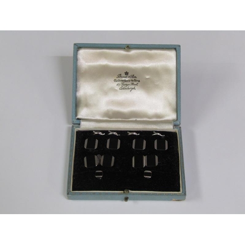 148 - A boxed set of 9ct white gold and black onyx cufflinks and studs.