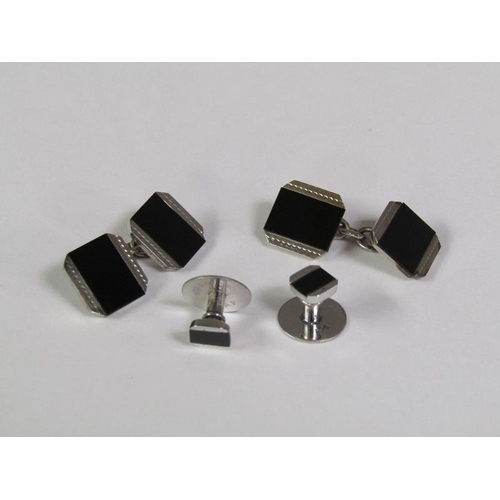 148 - A boxed set of 9ct white gold and black onyx cufflinks and studs.