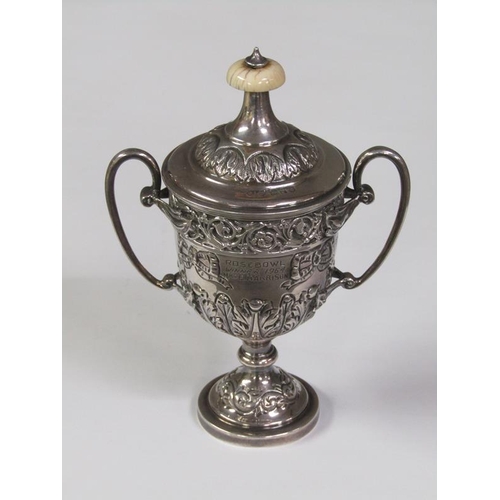 168 - A two handled silver trophy, embossed and chased, London 1910, 6oz t, 14cm h.