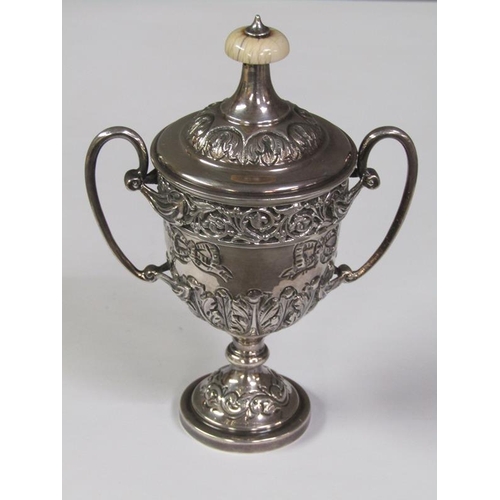 168 - A two handled silver trophy, embossed and chased, London 1910, 6oz t, 14cm h.