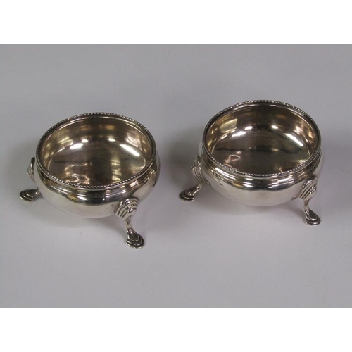 177 - A pair of late Georgian salt cellars with gadroon upper rims and supported on three hoofed feet, Lon... 