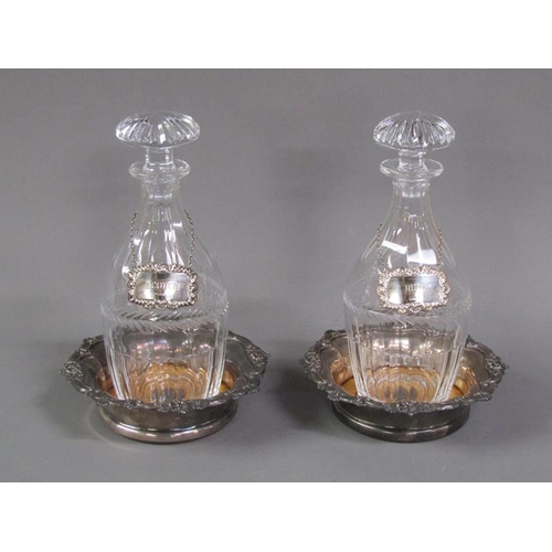 209 - A pair of 19c cut glass decanters with silver labels, together with a pair of Sheffield plated coast... 